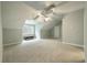 Spacious bedroom with large windows and a ceiling fan at 1575 Tacky Point Rd, Wadmalaw Island, SC 29487