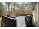 Large deck with two grills and a view of the woods at 1575 Tacky Point Rd, Wadmalaw Island, SC 29487