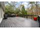 Spacious deck with built-in grill and wooded backdrop at 1575 Tacky Point Rd, Wadmalaw Island, SC 29487