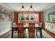 Rustic dining room with wooden table and access to a deck at 1575 Tacky Point Rd, Wadmalaw Island, SC 29487