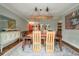 Elegant dining room featuring a rustic wooden table and unique lighting fixture at 1575 Tacky Point Rd, Wadmalaw Island, SC 29487