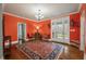 Entryway with orange walls, hardwood floors, and access to backyard at 1575 Tacky Point Rd, Wadmalaw Island, SC 29487