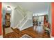 Spacious entryway with hardwood floors, a staircase, and views to the dining area at 1575 Tacky Point Rd, Wadmalaw Island, SC 29487