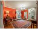 Entryway with orange walls, hardwood floors, and comfortable seating at 1575 Tacky Point Rd, Wadmalaw Island, SC 29487