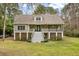 Two-story house with a wraparound porch and spacious lawn at 1575 Tacky Point Rd, Wadmalaw Island, SC 29487
