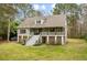 Two story house with a large front yard and driveway at 1575 Tacky Point Rd, Wadmalaw Island, SC 29487