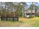 House exterior view with a black fence in the foreground at 1575 Tacky Point Rd, Wadmalaw Island, SC 29487