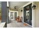 Relaxing front porch with comfy seating and a ceiling fan at 1575 Tacky Point Rd, Wadmalaw Island, SC 29487