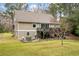 Two story house with deck and patio furniture at 1575 Tacky Point Rd, Wadmalaw Island, SC 29487