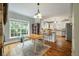 Eat-in kitchen with white cabinets and hardwood floors at 1575 Tacky Point Rd, Wadmalaw Island, SC 29487