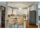 White kitchen with granite countertops and breakfast bar at 1575 Tacky Point Rd, Wadmalaw Island, SC 29487