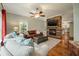 Spacious living room featuring a cozy fireplace and hardwood floors at 1575 Tacky Point Rd, Wadmalaw Island, SC 29487