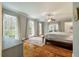 Bright bedroom with hardwood floors, large windows, and access to a private balcony at 1575 Tacky Point Rd, Wadmalaw Island, SC 29487