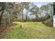 Landscaped yard with stone pathway and trees at 1575 Tacky Point Rd, Wadmalaw Island, SC 29487