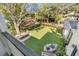 Large backyard with lush lawn, mature trees, and patio seating at 1750 Ion Ave, Sullivans Island, SC 29482