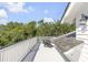 Private balcony with white railings and two black adirondack chairs at 1750 Ion Ave, Sullivans Island, SC 29482