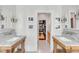 Bathroom with double vanity, marble countertops, and walk-in closet access at 1750 Ion Ave, Sullivans Island, SC 29482