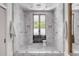 Spa-like bathroom with marble shower, double shower heads, and patterned floor at 1750 Ion Ave, Sullivans Island, SC 29482