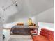 Charming attic bedroom with plush seating and a cozy bed at 1750 Ion Ave, Sullivans Island, SC 29482