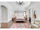 Bright bedroom with four-poster bed, area rug, and access to private balcony at 1750 Ion Ave, Sullivans Island, SC 29482