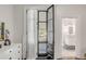 Bedroom with en-suite bathroom and access to a private porch at 1750 Ion Ave, Sullivans Island, SC 29482