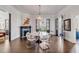 Spacious dining room with hardwood floors, round marble table, and modern white chairs at 1750 Ion Ave, Sullivans Island, SC 29482