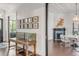 Bright entryway with hardwood floors, antique console table, and gallery wall showcasing framed art at 1750 Ion Ave, Sullivans Island, SC 29482