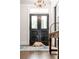 Elegant entryway with hardwood floors and statement chandelier at 1750 Ion Ave, Sullivans Island, SC 29482