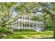 Two story home with wrap around porch and mature landscaping at 1750 Ion Ave, Sullivans Island, SC 29482