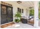 Spacious front porch with seating area and lush greenery at 1750 Ion Ave, Sullivans Island, SC 29482