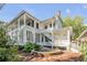 Two-story white house with large porch, fountain, and lush landscaping at 1750 Ion Ave, Sullivans Island, SC 29482