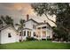 Charming white house with a spacious backyard and detached shed at 1750 Ion Ave, Sullivans Island, SC 29482