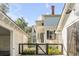 White house with black accents and gated courtyard at 1750 Ion Ave, Sullivans Island, SC 29482