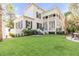 White two-story house with large porch and lush lawn at 1750 Ion Ave, Sullivans Island, SC 29482