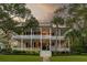 Two story home with double porches and palm trees at 1750 Ion Ave, Sullivans Island, SC 29482