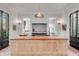 Modern kitchen island with wood top and stainless steel cabinets, open to a breakfast area at 1750 Ion Ave, Sullivans Island, SC 29482