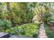 Stone path meandering through a verdant garden at 1750 Ion Ave, Sullivans Island, SC 29482