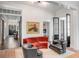 Elegant living room with red sofa and black armchairs at 1750 Ion Ave, Sullivans Island, SC 29482
