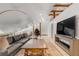 Spacious attic playroom with leather couch, TV, and hanging chair at 1750 Ion Ave, Sullivans Island, SC 29482