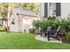 Relaxing side yard with two black adirondack chairs at 1750 Ion Ave, Sullivans Island, SC 29482