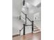Elegant staircase with black and white railings and hardwood floors at 1750 Ion Ave, Sullivans Island, SC 29482