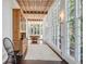 Sunroom with wooden ceiling, lots of windows, and antique furniture at 1750 Ion Ave, Sullivans Island, SC 29482