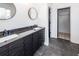 Bathroom with double vanity, dark wood cabinets, and large mirrors at 1800 Palmetto Isle Dr, Mount Pleasant, SC 29466
