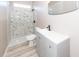 Bathroom with a shower/tub combo, vanity, and marble-look walls at 1800 Palmetto Isle Dr, Mount Pleasant, SC 29466
