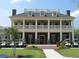 Elegant clubhouse with columns and golf cart parking at 1800 Palmetto Isle Dr, Mount Pleasant, SC 29466