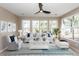 Bright living room with large windows, comfy seating, and a stylish coffee table at 1800 Palmetto Isle Dr, Mount Pleasant, SC 29466