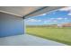 Covered back patio with ample space overlooks the backyard and scenic views beyond at 211 Bilge Rd, Ridgeville, SC 29472
