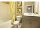 Charming bathroom with yellow accents, shower/tub combo and single vanity at 211 Bilge Rd, Ridgeville, SC 29472