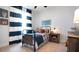 Cozy bedroom with a metal bed frame, striped curtains, and rustic wood furniture at 211 Bilge Rd, Ridgeville, SC 29472
