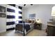 Charming bedroom with metal bed frame, navy and white striped curtains, and wood nightstand at 211 Bilge Rd, Ridgeville, SC 29472